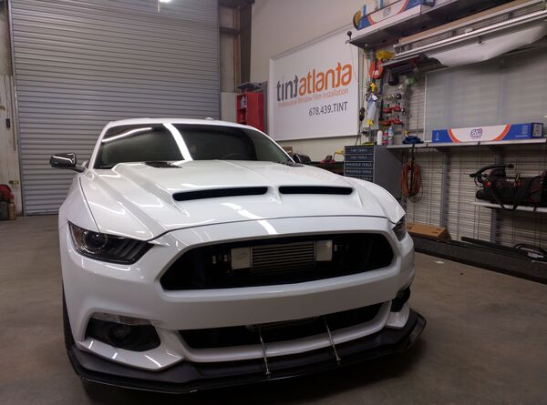 Ford Mustang GT front view showing professional dark window tint by TintButler