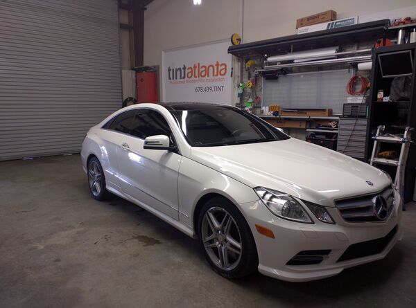 White Mercedes-Benz E-Class Coupe with professional window tinting Waco