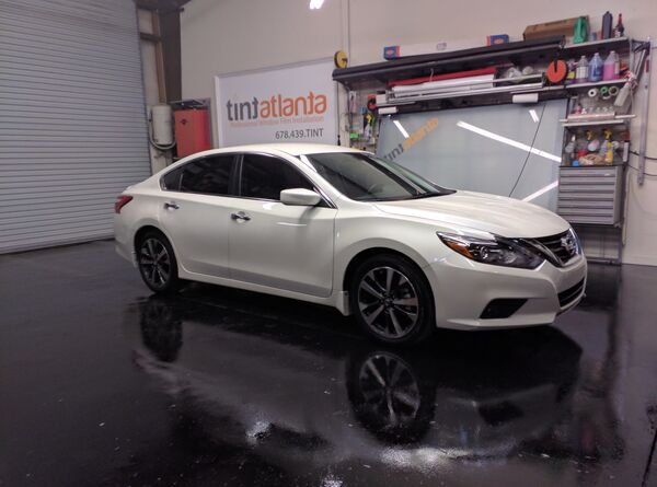 White Nissan Altima sedan with window tint installation TintButler